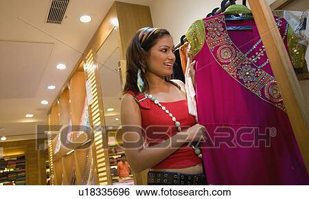 Woman selecting clothes View Large Photo Image Stock Photograph - Woman selecting clothes. Fotosearch