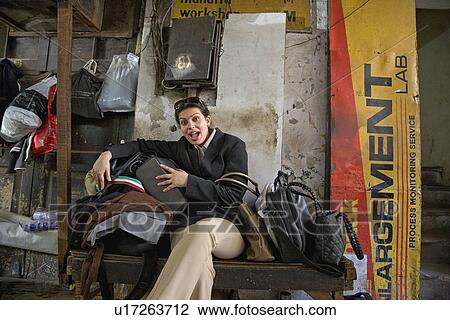 Woman sitting in a room View Large Photo Image Stock Image - Woman sitting in a room. Fotosearch
