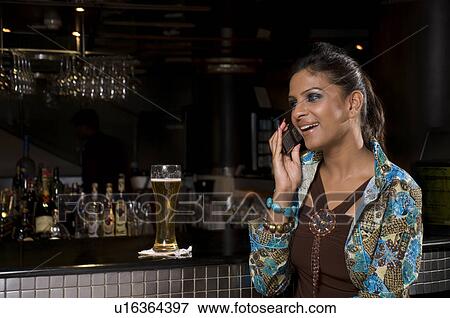 Stock Photo - Woman talking on her phone. Fotosearch