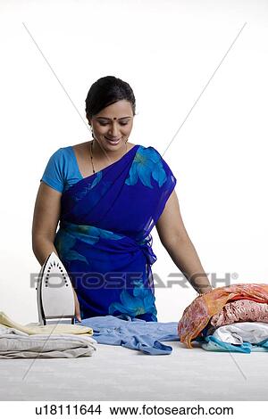 Picture - Woman with electric iron. Fotosearch