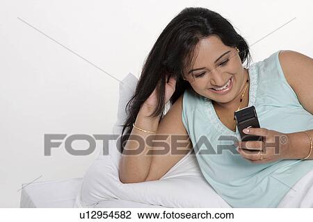 Stock Image - Woman with her phone. Fotosearch