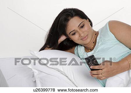 Woman with her phone View Large Photo Image Stock Photo - Woman with her phone. Fotosearch