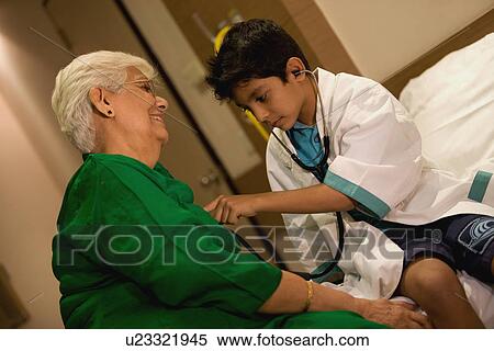 Stock Photography - Young boy plays doctor. Fotosearch