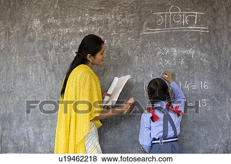 Young girl writing on the board View Large Photo Image Stock Photo - Young girl writing on the board. Fotosearch