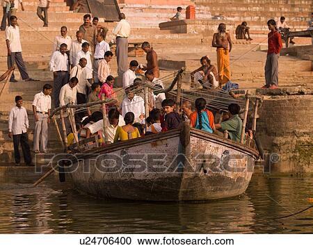 Boat load of people on the Ganges River in India View Large Photo Image Stock Image - Boat load of people on the Ganges River in India. Fotosearch