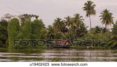 Stock Image - "Boat on backwater, Kerala, South India". Fotosearch