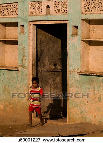 Boy coming out of building in India View Large Photo Image Stock Photo - Boy coming out of building in India. Fotosearch