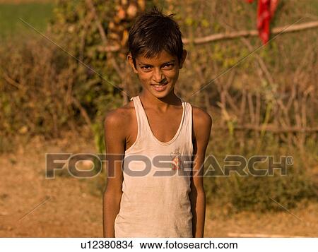 Boy in front of fence in India View Large Photo Image Picture - Boy in front of fence in India. Fotosearch