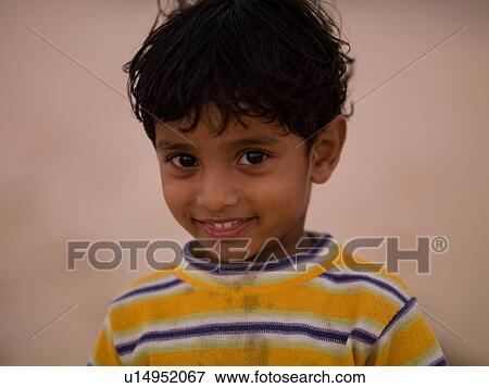 Stock Photo - Close up of a young smiling boy in India. Fotosearch