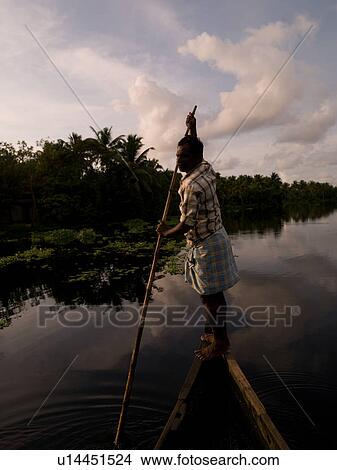 Picture - Fisherman on his boat in India. Fotosearch