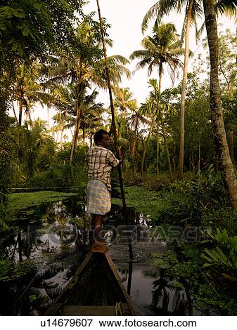 Stock Photo - Fisherman on his boat in India. Fotosearch