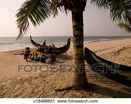 Stock Image - Fisherman on the beach of Arabian Sea. Fotosearch