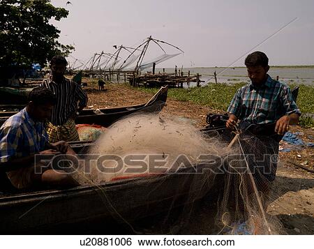 Stock Photograph - Fisherman on the beach of Arabian Sea. Fotosearch