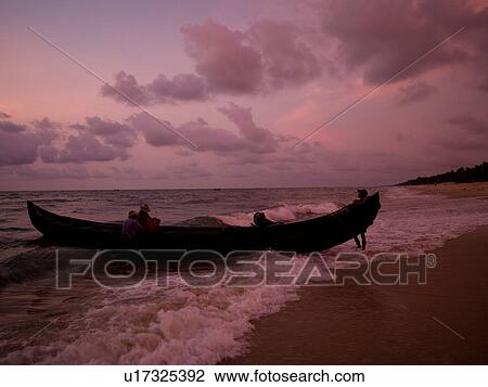 Stock Image - "Fishing boat on the beach of the Arabian Sea, Kerala, India". Fotosearch
