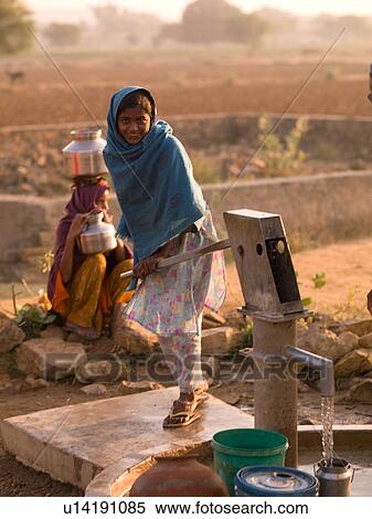 Girl pumping water from well in India View Large Photo Image Stock Photography - Girl pumping water from well in India. Fotosearch