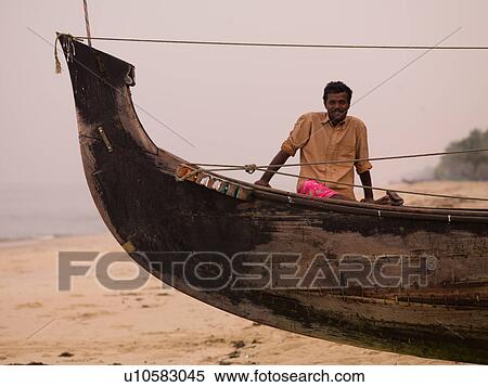 Man in his boat on beach in India View Large Photo Image Stock Photography - Man in his boat on beach in India. Fotosearch