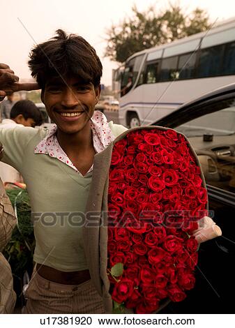 Man in India holding a bunch of roses View Large Photo Image Stock Image - Man in India holding a bunch of roses. Fotosearch