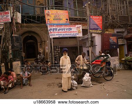 Stock Photo - Man in turban beside cart on street in India. Fotosearch