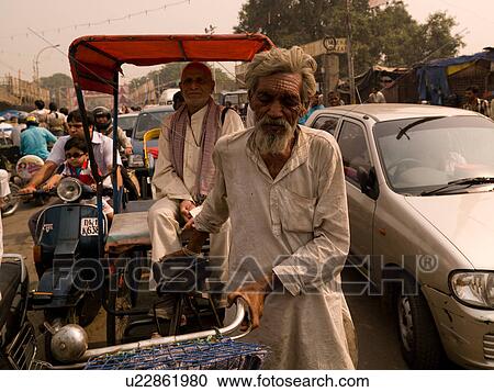 Man pushing bicycle through traffic in India View Large Photo Image Stock Image - Man pushing bicycle through traffic in India. Fotosearch