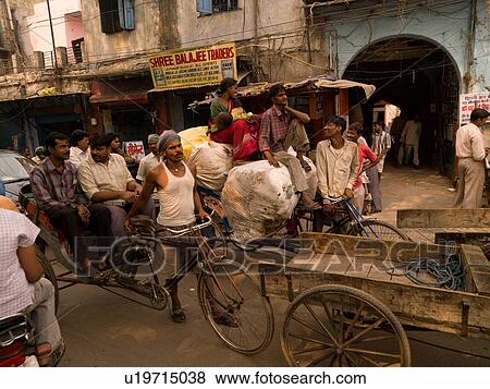 Man pushing bicycle through traffic in India View Large Photo Image Stock Photo - Man pushing bicycle through traffic in India. Fotosearch
