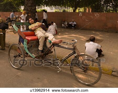 Man relaxing on bicycle in India View Large Photo Image Picture - Man relaxing on bicycle in India. Fotosearch