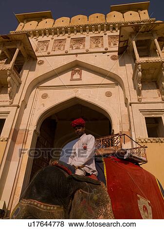 Stock Photo - Man riding an elephant in India. Fotosearch