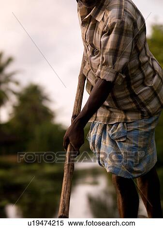 "Man rowing his boat in backwater, Kerala, South India" View Large Photo Image Stock Photography - "Man rowing his boat in backwater, Kerala, South India". Fotosearch
