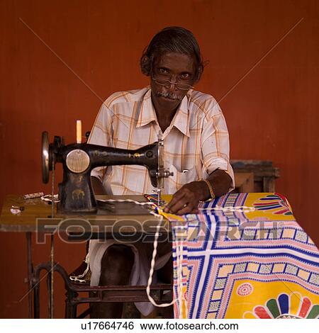 Stock Photograph - Man sewing in India. Fotosearch