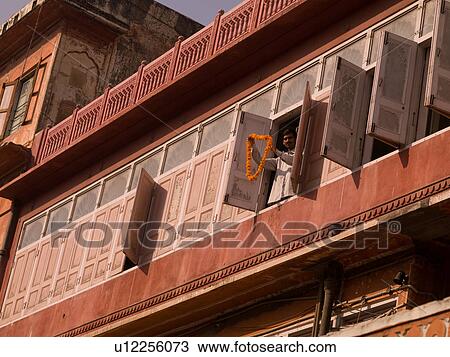 Man standing at a window in India View Large Photo Image Stock Image - Man standing at a window in India. Fotosearch