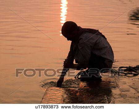 Man washing his hand in the Ganges River in India View Large Photo Image Stock Image - Man washing his hand in the Ganges River in India. Fotosearch