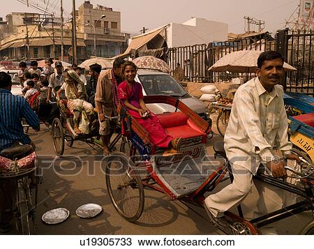 Man with passenger on bicycle in India View Large Photo Image Stock Image - Man with passenger on bicycle in India. Fotosearch