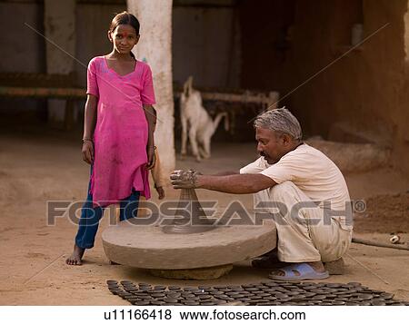 Man working with pottery in India View Large Photo Image Stock Photo - Man working with pottery in India. Fotosearch