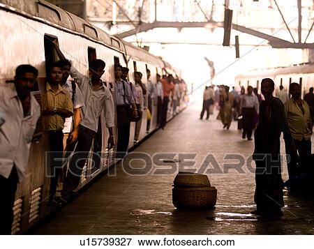 Stock Photo - Men leaning out of train in India. Fotosearch