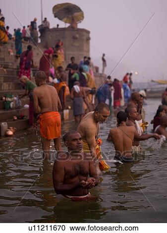 Men standing in the Ganges River in India View Large Photo Image Stock Image - Men standing in the Ganges River in India. Fotosearch
