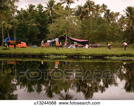 Stock Photo - People along the shoreline in Kerala India. Fotosearch