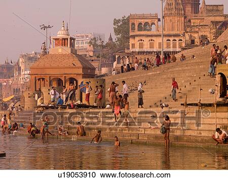 Stock Image - People at the edge of the Ganges River in India. Fotosearch
