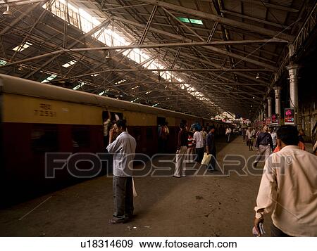 Stock Photo - People standing oustide train in India. Fotosearch