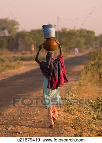 "Rajasthan, India - woman balancing containers on her head" View Large Photo Image Stock Photo - "Rajasthan, India - woman balancing containers on her head". Fotosearch