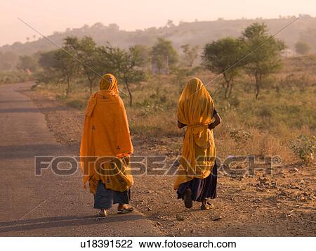 "Rajasthan, India - women walking down roadway" View Large Photo Image Stock Image - "Rajasthan, India - women walking down roadway". Fotosearch