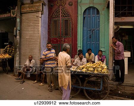 Stock Image - Vendor selling bananas in India. Fotosearch