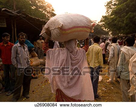 "Woman carrying a sack on her head in Agra, India" View Large Photo Image Picture - "Woman carrying a sack on her head in Agra, India". Fotosearch