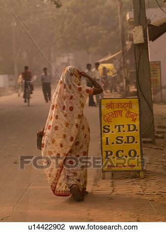 "Woman in a sari walking down street in Agra, India" View Large Photo Image Stock Image - "Woman in a sari walking down street in Agra, India". Fotosearch
