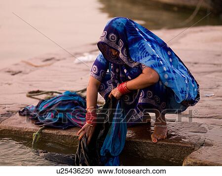 "Woman washing coths in the Ganges River, India" View Large Photo Image Stock Image - "Woman washing coths in the Ganges River, India". Fotosearch