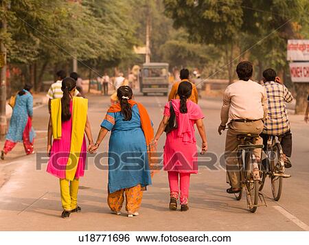 "Women holding hands walking down street in Agra, India" View Large Photo Image Stock Photograph - "Women holding hands walking down street in Agra, India". Fotosearch