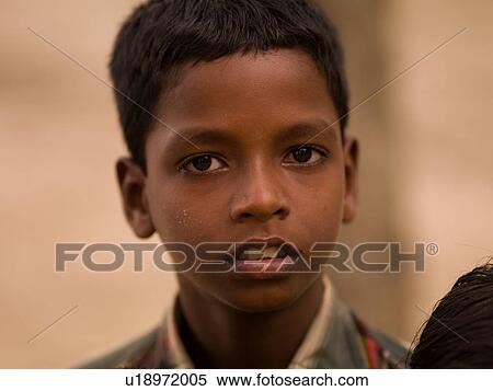 Young boy looking at camera View Large Photo Image Stock Photography - Young boy looking at camera. Fotosearch