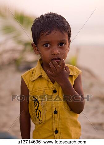 Young boy with his hands in his mouth in India View Large Photo Image Stock Photograph - Young boy with his hands in his mouth in India. Fotosearch