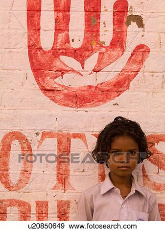 Young girl standing in front of a painted wall in India View Large Photo Image Stock Photo - Young girl standing in front of a painted wall in India. Fotosearch
