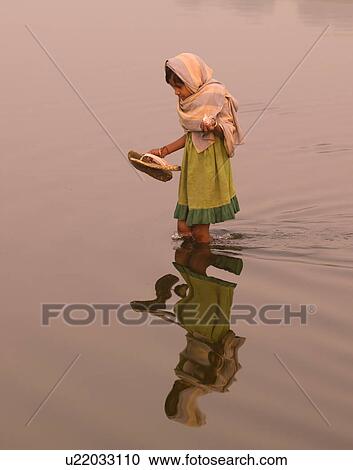 Young girl standing in knee deep water in India View Large Photo Image Stock Image - Young girl standing in knee deep water in India. Fotosearch