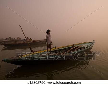 Young girl standing on a boat in India View Large Photo Image Stock Image - Young girl standing on a boat in India. Fotosearch