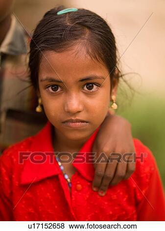 Stock Photo - Young girl with hand on her shoulder. Fotosearch